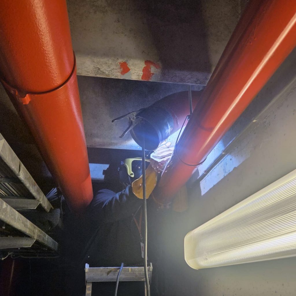 En rørlegger installerer sprinkelsystem